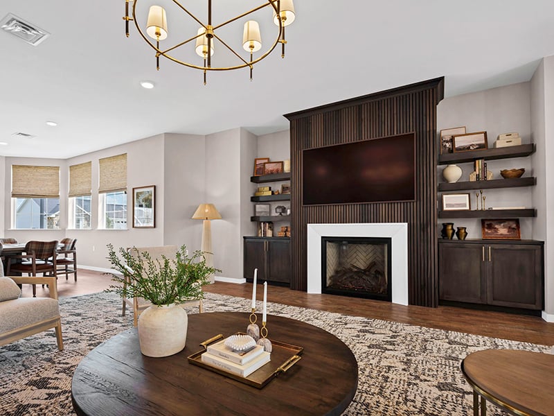 Cozy clubhouse lounge with sofas and armchairs at Cedarhurst of Topeka's Independent Living at Cedarhurst Cottages