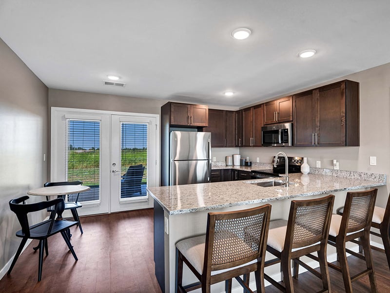 A full kitchen with island inside of Cedarhurst of Topeka's Independent Living at Cedarhurst Cottages