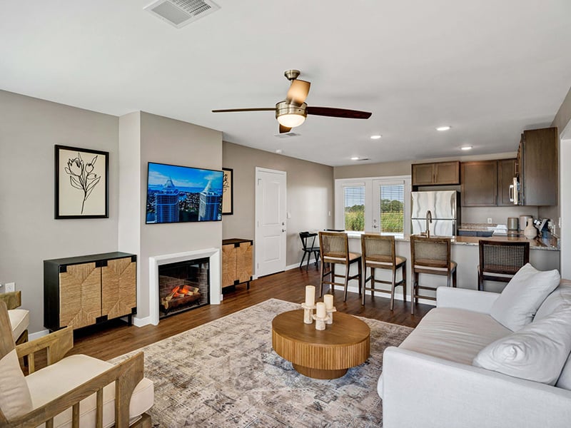 Open-concept living room and kitchen inside of Cedarhurst of Topeka's Independent Living at Cedarhurst Cottages
