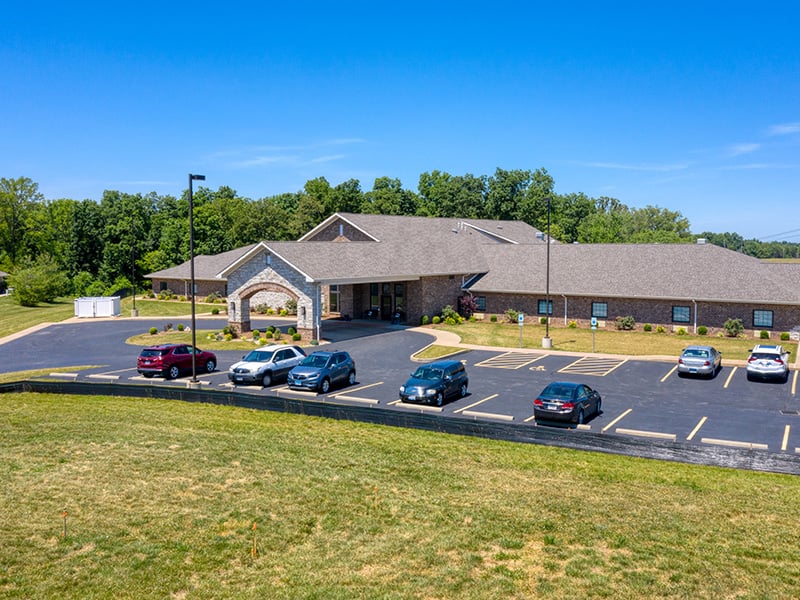 Aerial view of the entire Cedarhurst of Waterloo senior living community building and spacious parking lot