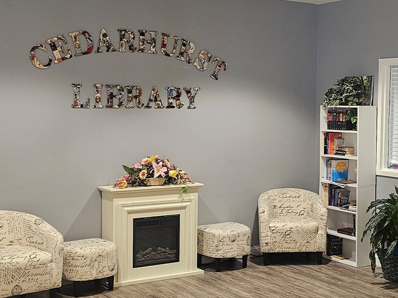 A welcoming, senior-friendly library at Cedarhurst of Waterloo with accessible resources for reading and relaxation