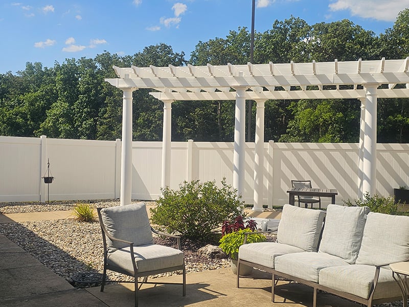 An inviting outdoor area at Cedarhurst of Waterloo, showing comfortable seating, a pergola, and a covered patio