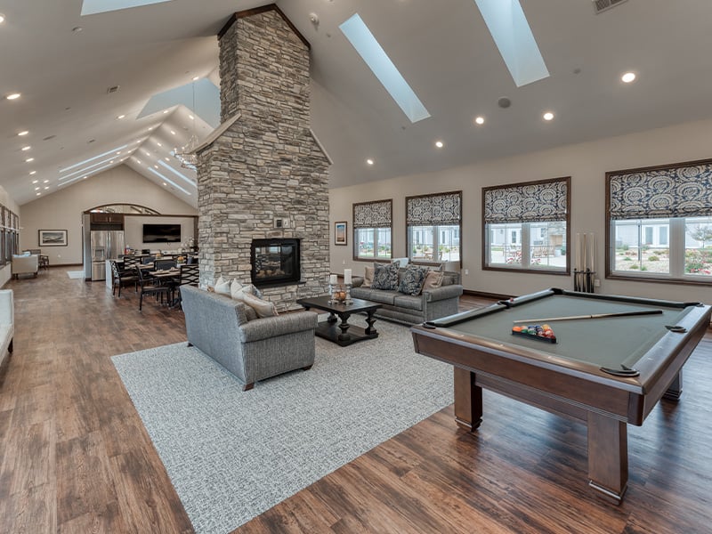 Cedarhurst of West Plains's cozy common area, complete with a warm fireplace, pool table, and comfortable seating