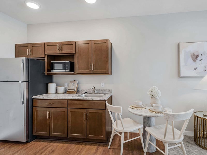 An accessible kitchenette in a senior apartment at Cedarhurst of Wichita, designed for ease of use and independence