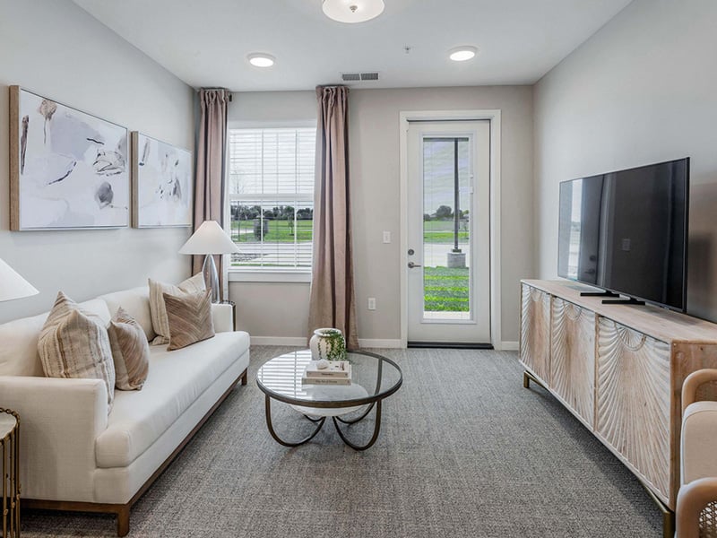 Senior-friendly apartment living room at Cedarhurst of Wichita, offering comfortable and accessible design for residents
