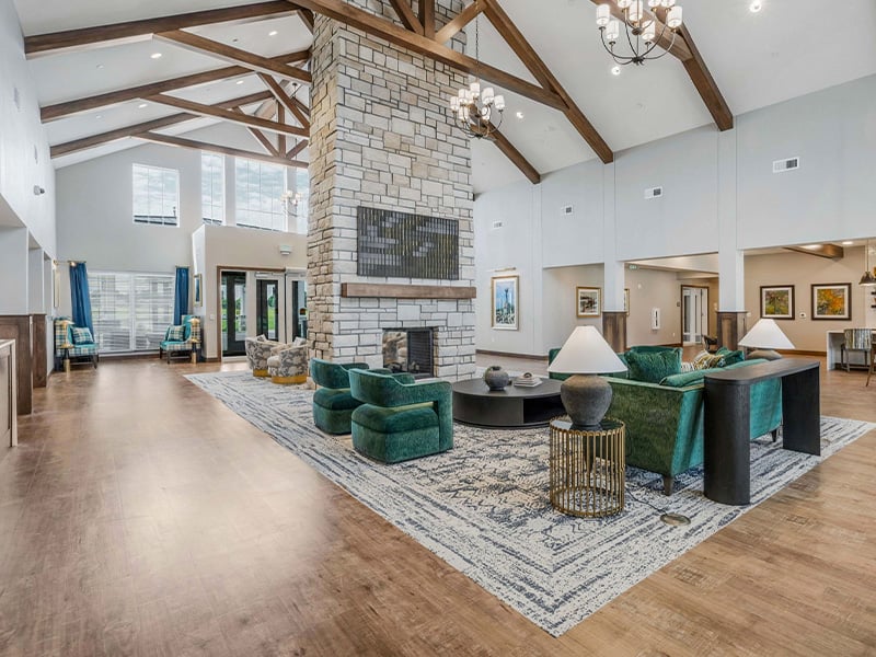 Cedarhurst of Wichita 's cozy common area, complete with a warm fireplace and comfortable seating