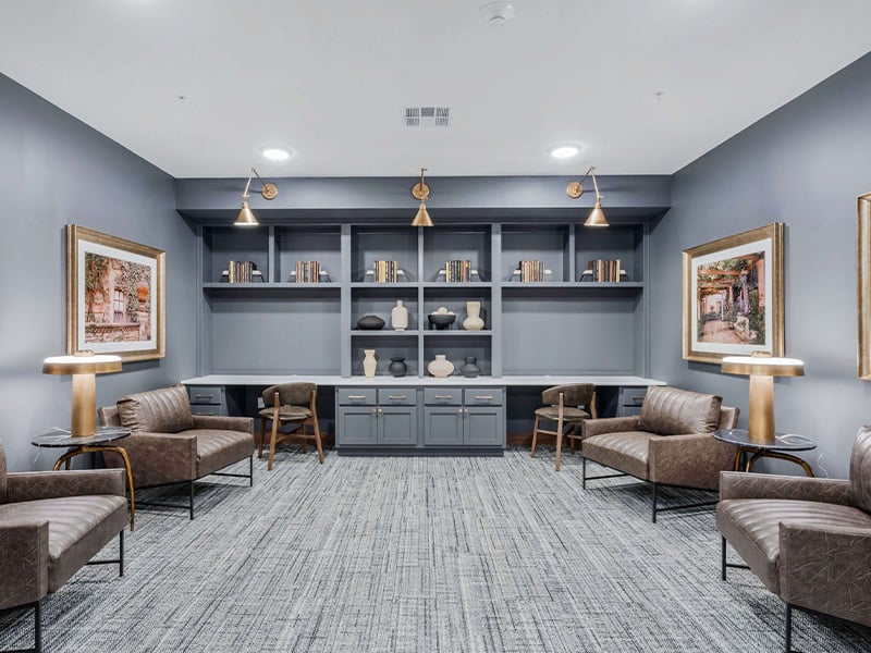 A welcoming, senior-friendly library at Cedarhurst of Wichita  with accessible resources for reading and relaxation