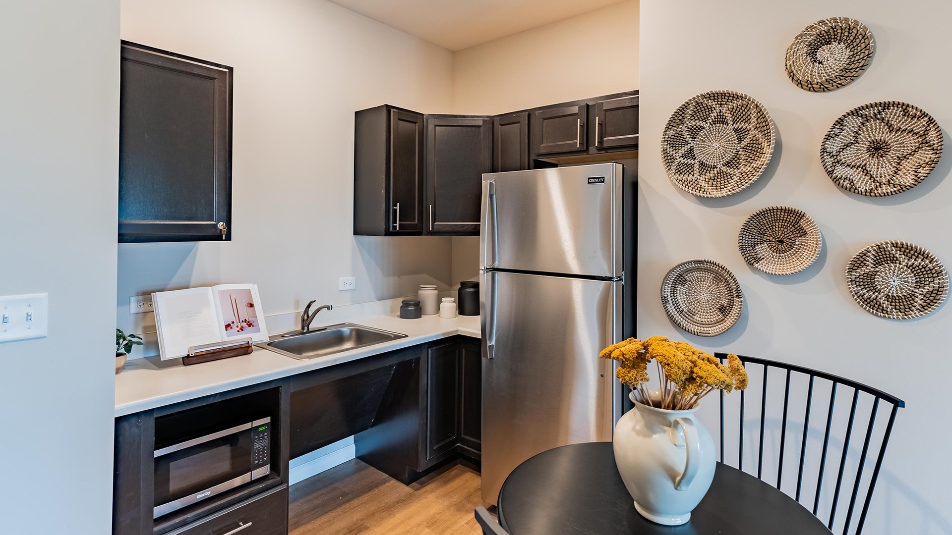 An accessible kitchenette in a senior apartment at Cedarhurst of Woodstock, designed for ease of use and independence