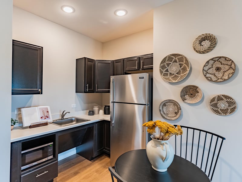 An accessible kitchenette in a senior apartment at Cedarhurst of Woodstock, designed for ease of use and independence