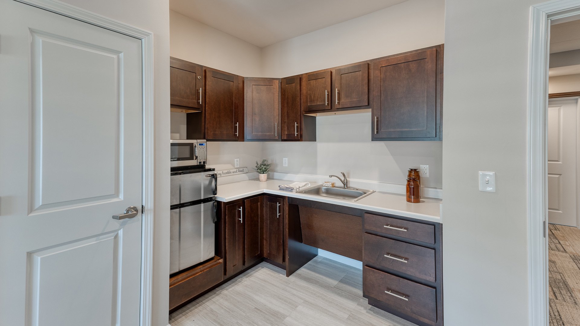 An accessible kitchenette in a senior apartment at Cedarhurst of Yorkville, designed for ease of use and independence