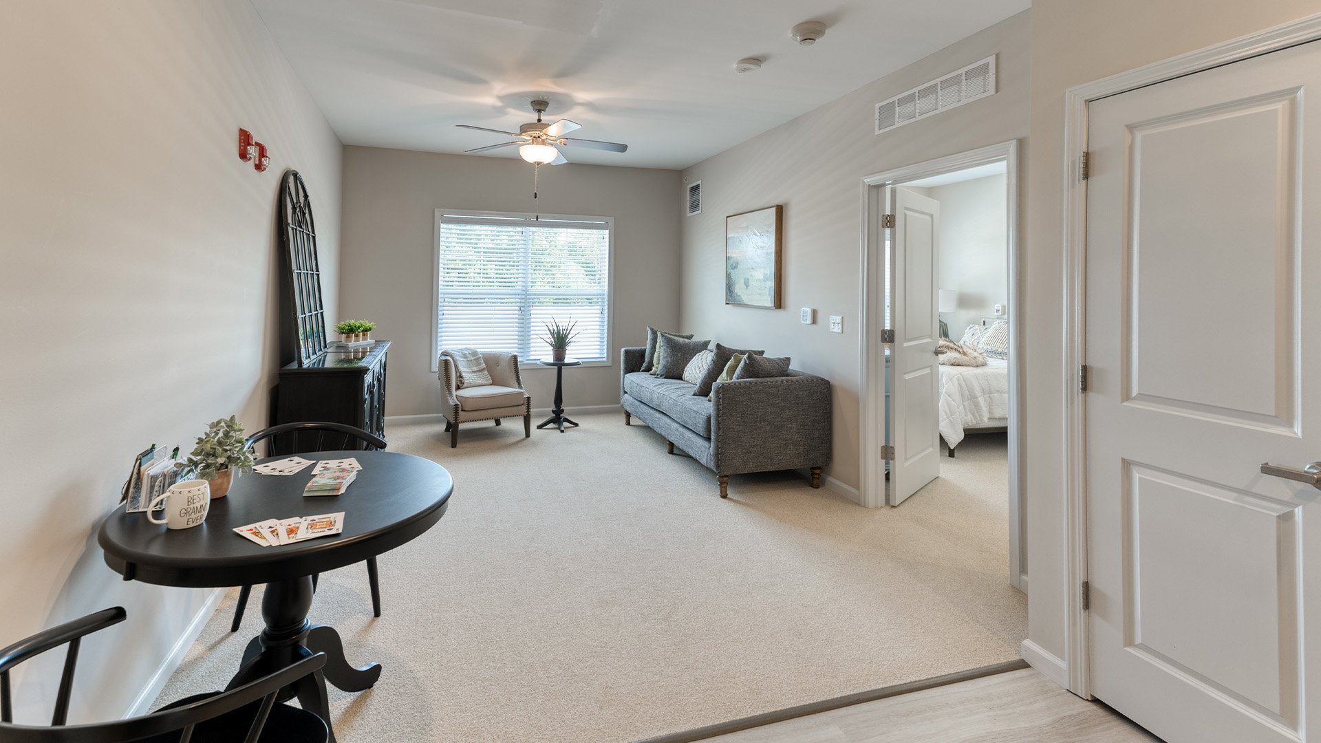 Senior-friendly apartment living room at Cedarhurst of Yorkville, offering comfortable and accessible design for residents