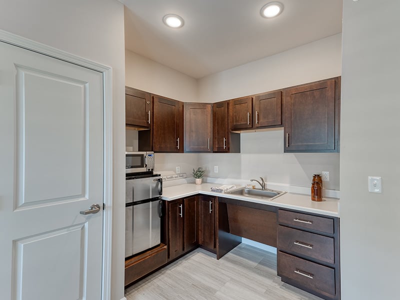 An accessible kitchenette in a senior apartment at Cedarhurst of Yorkville, designed for ease of use and independence