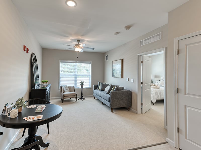 Senior-friendly apartment living room at Cedarhurst of Yorkville, offering comfortable and accessible design for residents