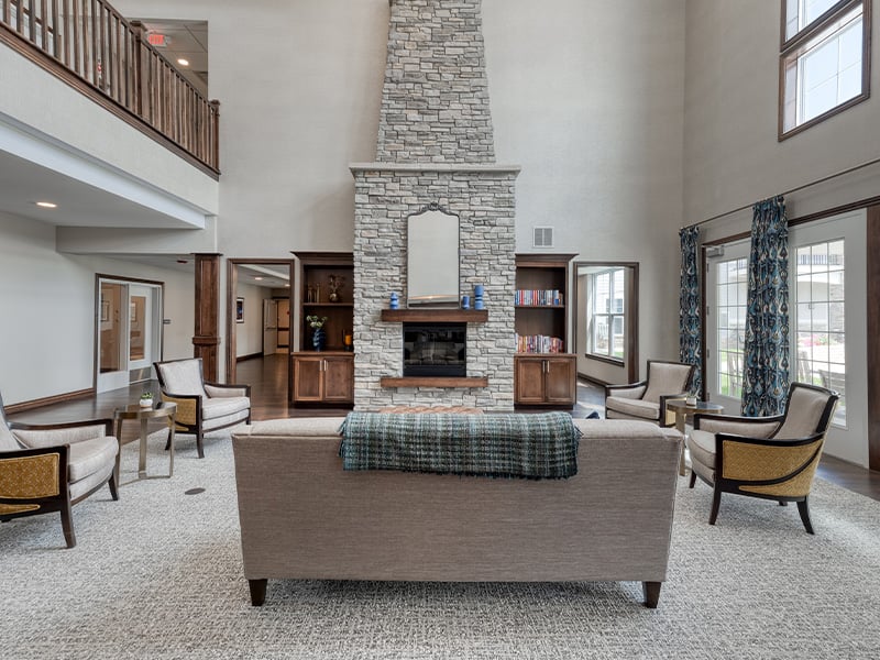Cedarhurst of Yorkville 's cozy common area, complete with a warm fireplace and comfortable seating