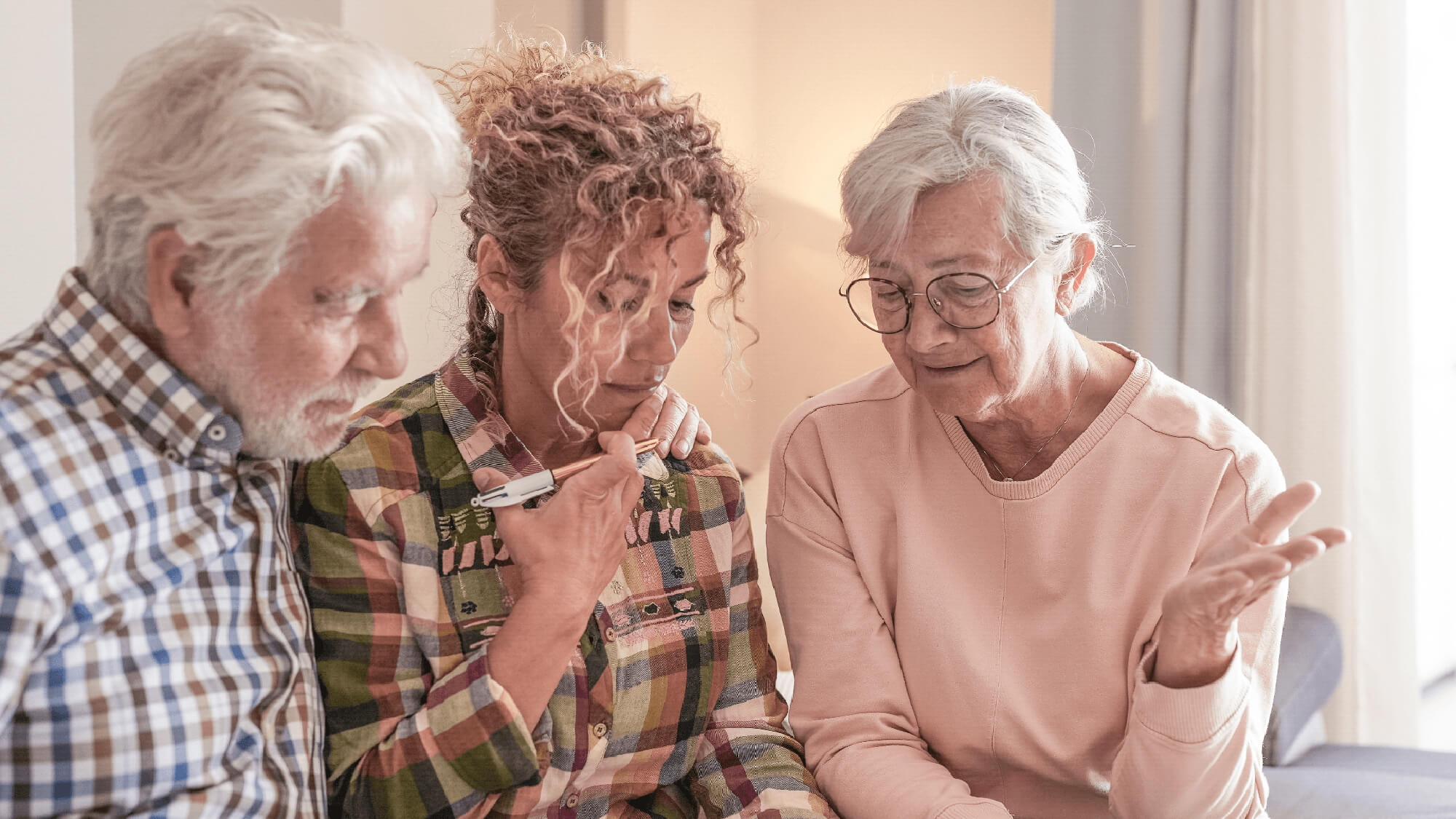 Adult child discussing plans with senior parents