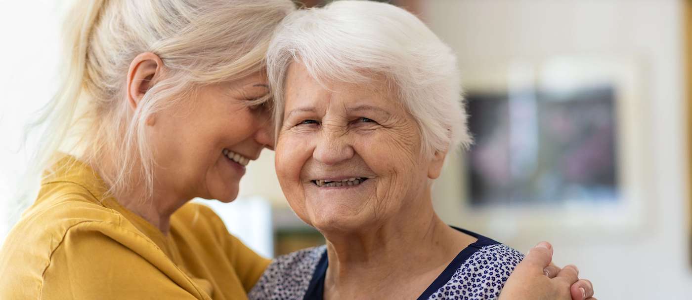 senior woman hugging daughter
