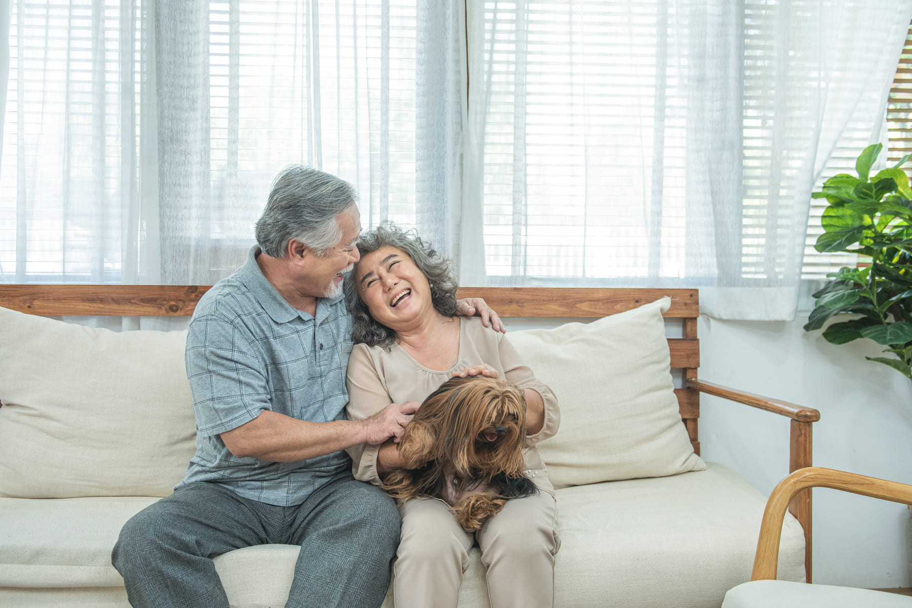 senior asian couple with dog at senior living community