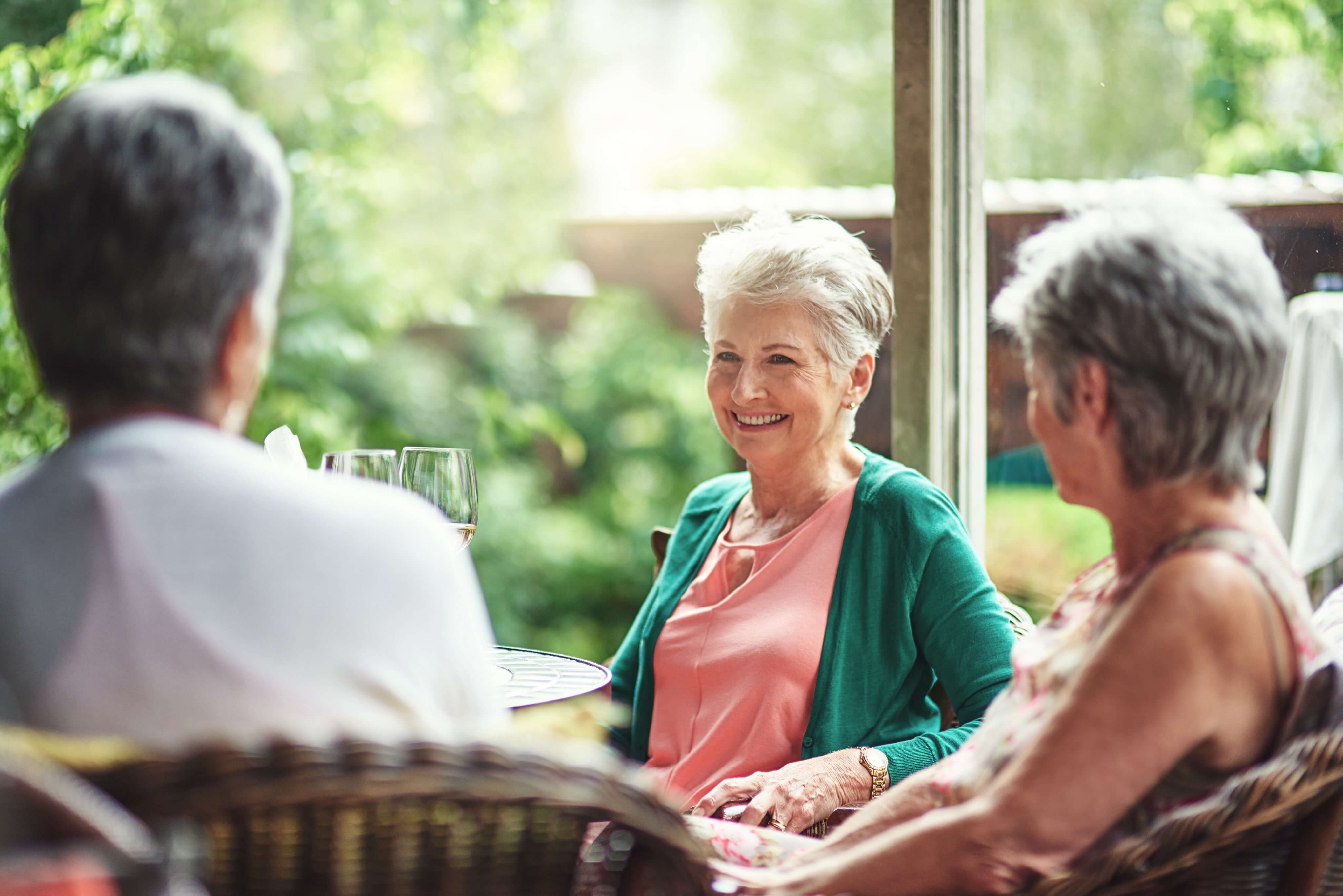 Three senior women sitting outdoors