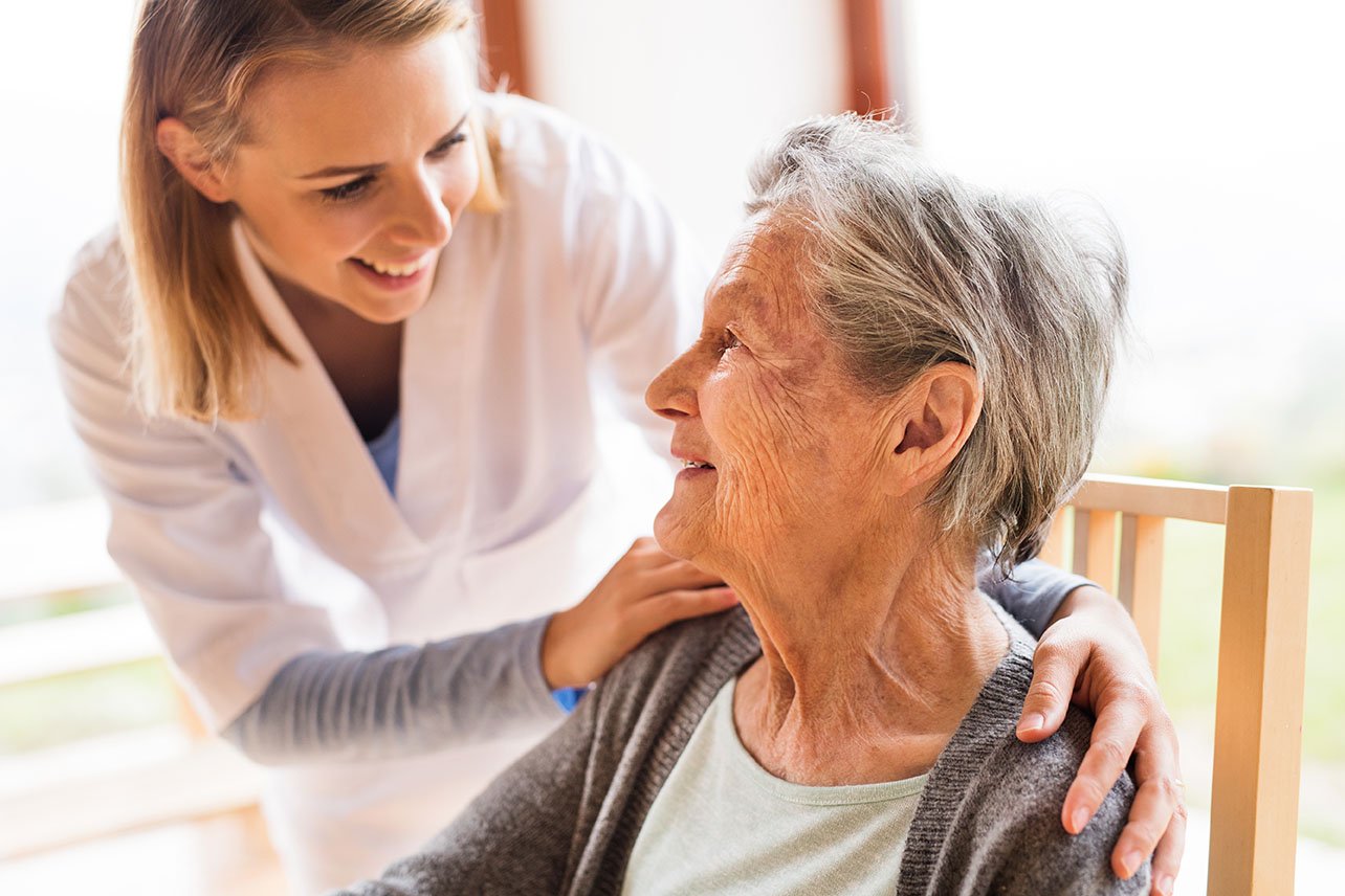 caregiver smiling with senior woman