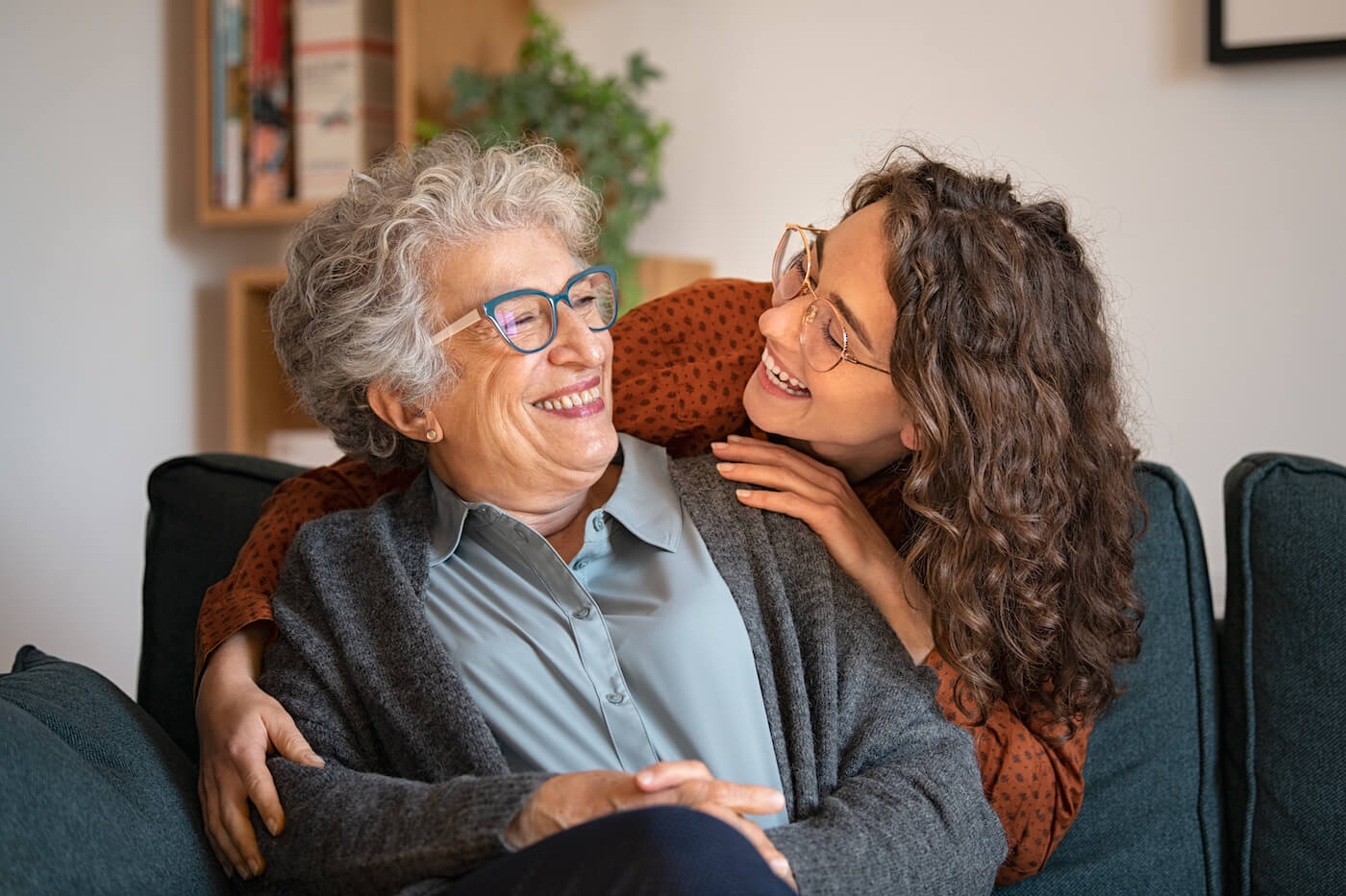 An adult child and her mother hugging