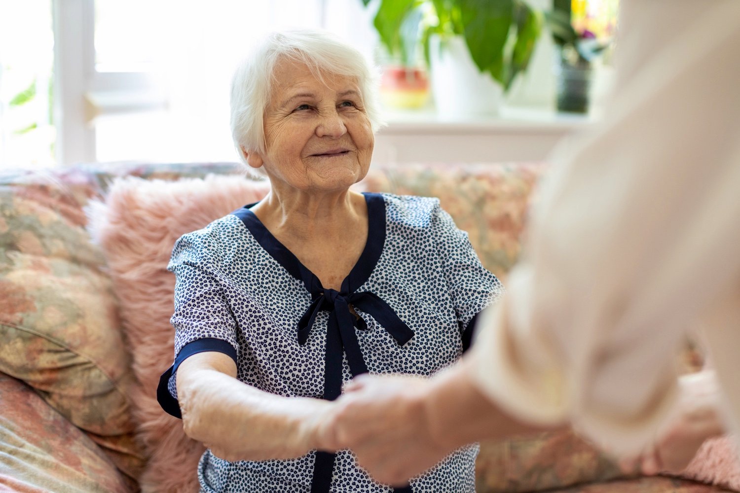 senior woman holding hands