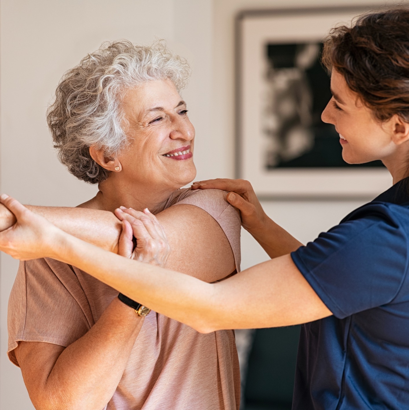 Senior woman with trainer exercising at home