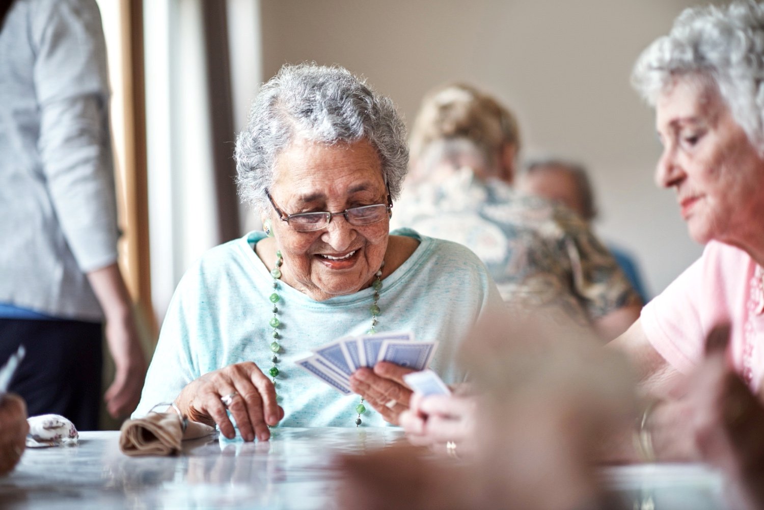 Senior woman playing cards