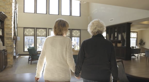 senior walking into a senior community with a family member
