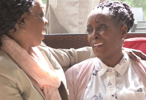 senior woman talking with adult daughter