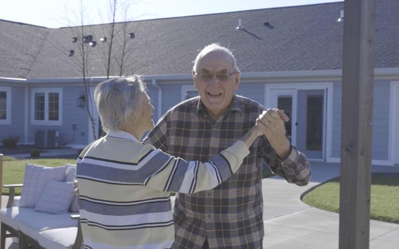 seniors dancing at senior living community courtyard