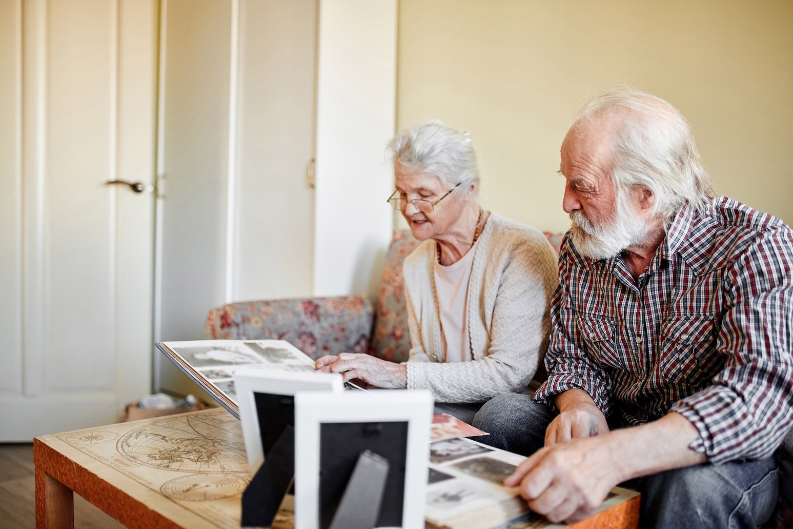 Seniors looking at old photo albums together