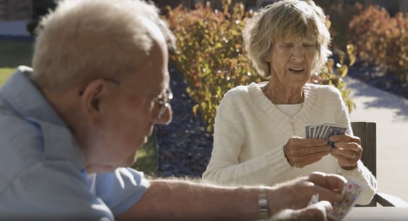 seniors playing cards outside