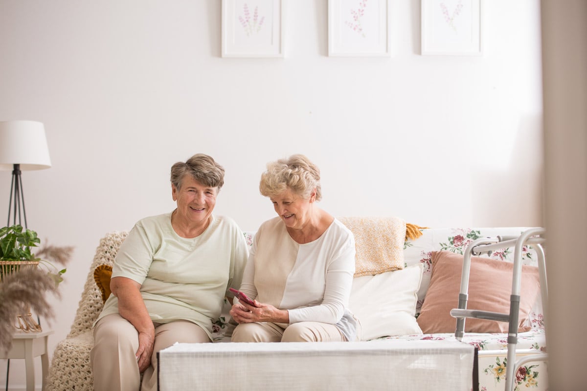 seniors sitting and smiling in home