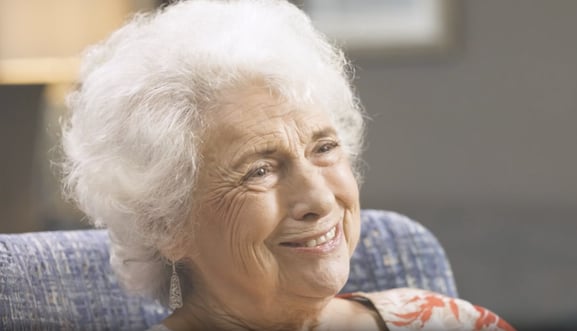 senior woman sitting for testimonial interview