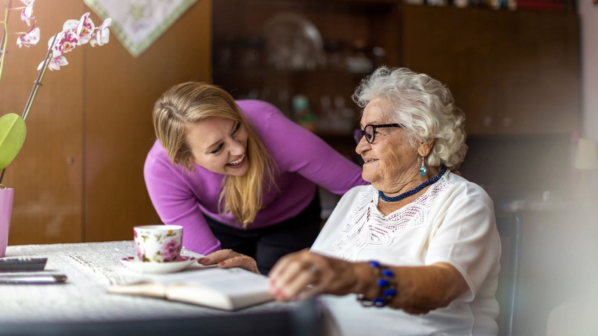 Senior living resident spending time with Cedarhurst staff member
