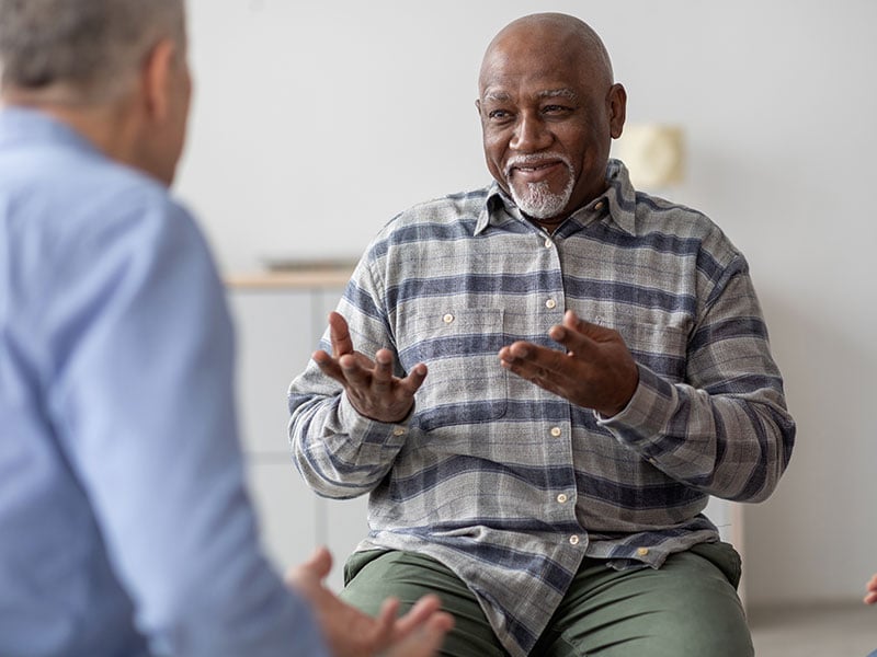 Cheerful African American elderly man having a conversation
