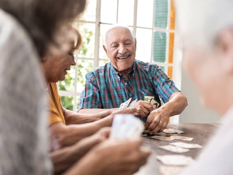 Senior living residents playing cards together