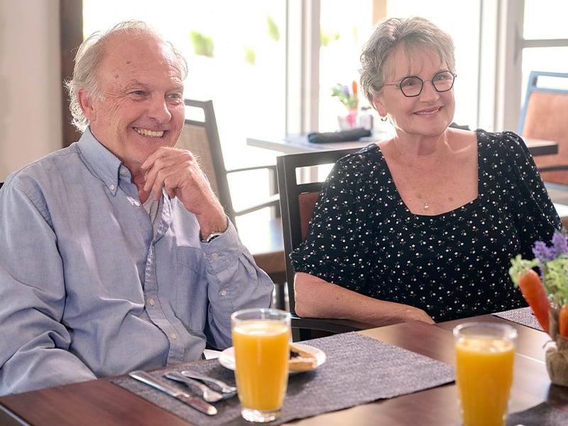 Senior living residents having breakfast in the dining room