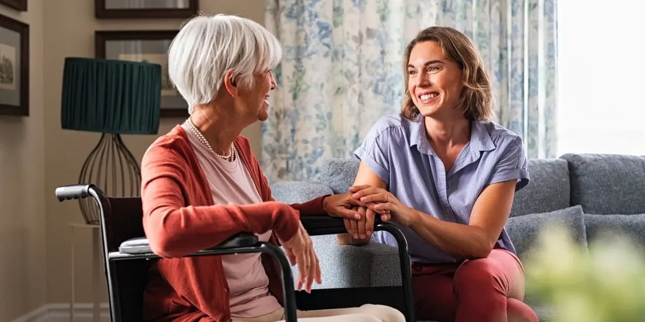 Happy adult woman visiting her elderly mother