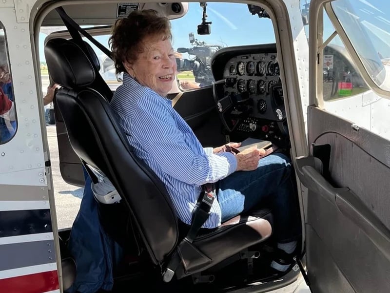 A senior woman sitting in an airplane