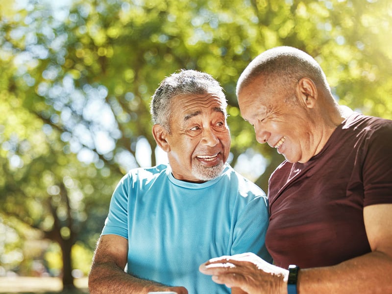 Two senior living residents spending time outside