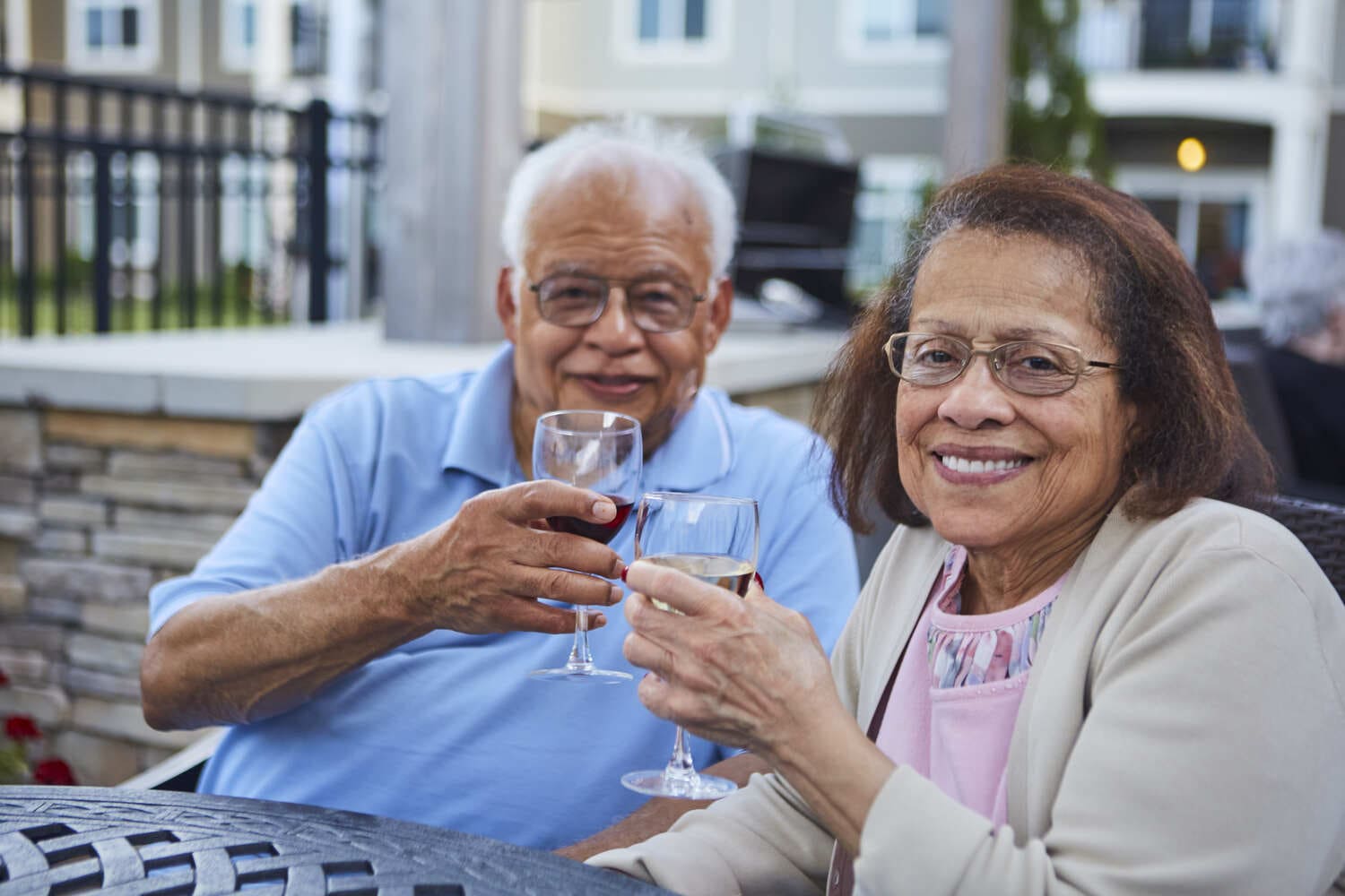 senior couple smiling and drinking wine