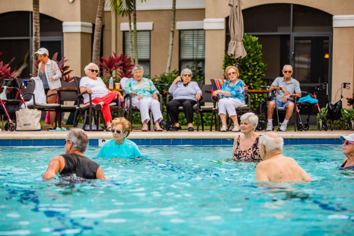 seniors in a pool and sitting on the edge