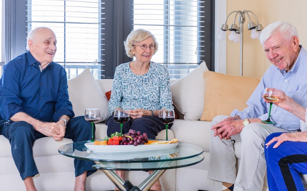 Seniors socializing in a private living room