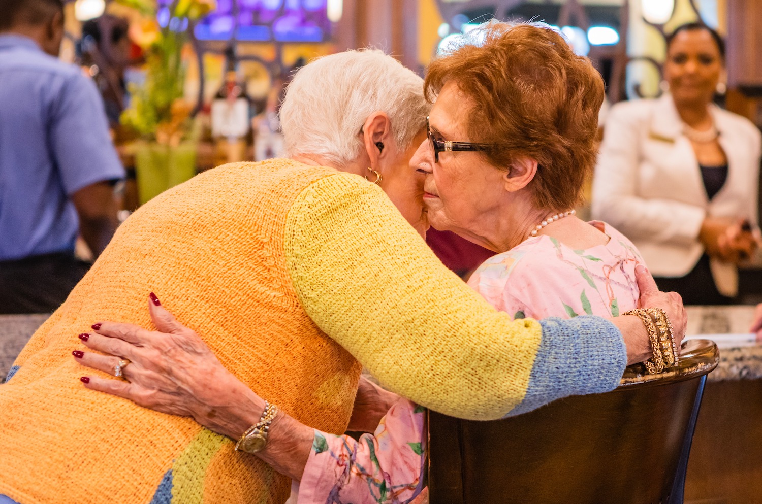 Senior women hugging at a party