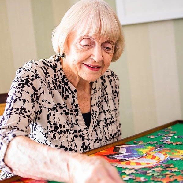 a senior resident completing a puzzle