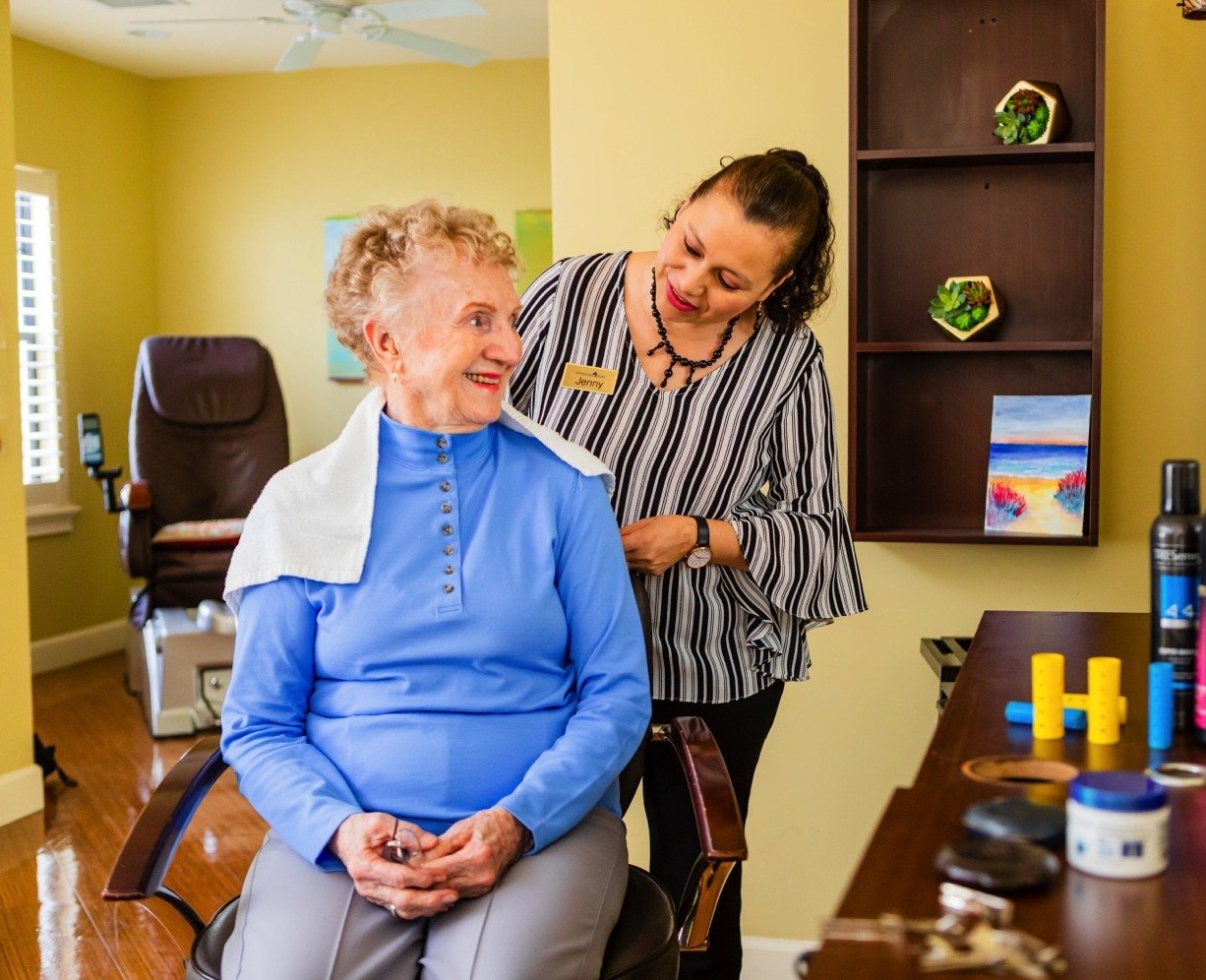 Senior woman getting a hair cut in the community salon