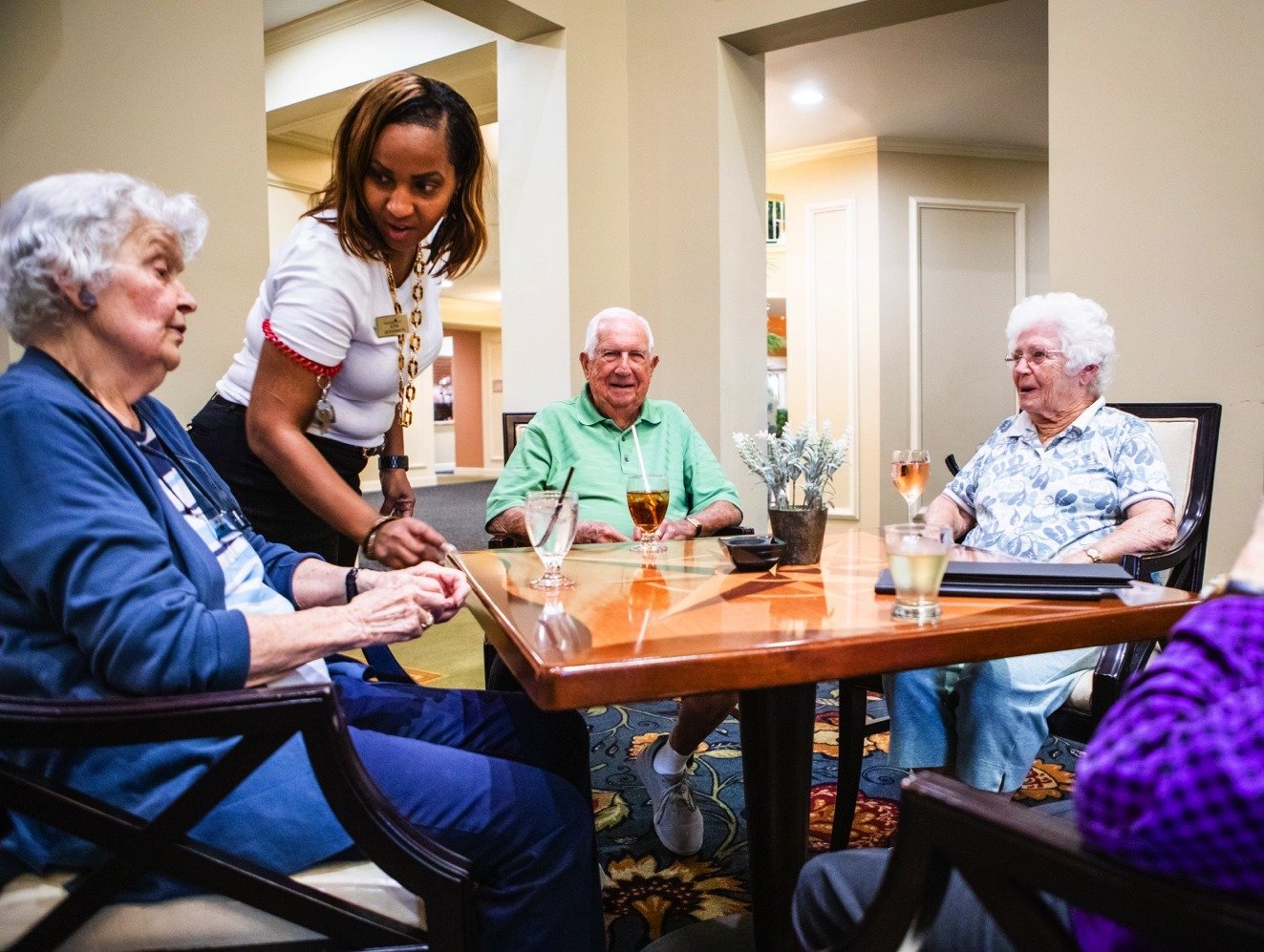 Senior friends having drinks and talking