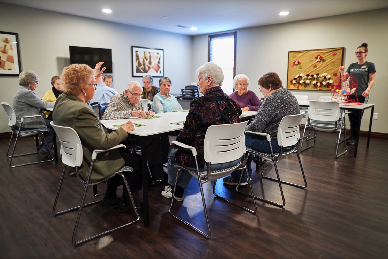 A group of seniors seated around a table playing bingo