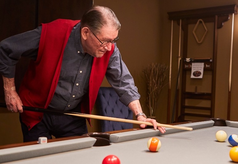 Senior man playing pool